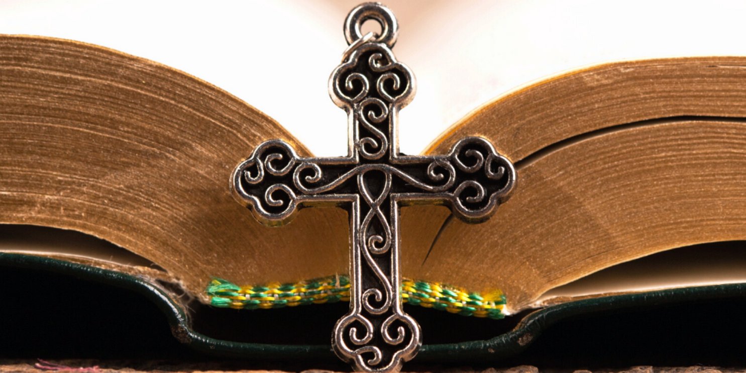 Bible open with a crucifix on the book's spine - Soulshine's Bible Section