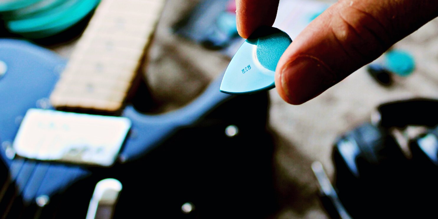 Hand holding guitar pick - Soulshine Guitar Accessories section