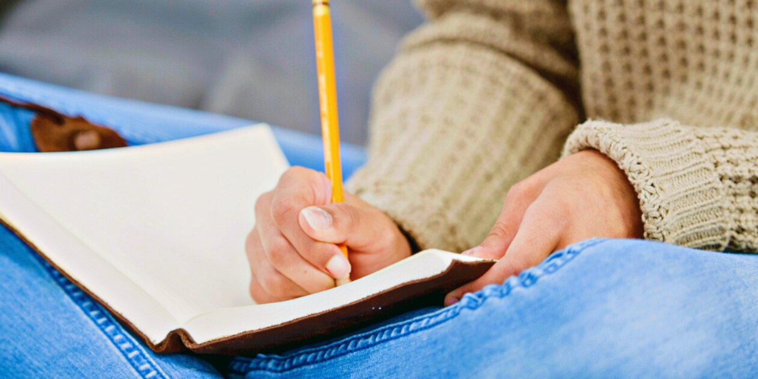 Woman journaling with a pencil in her lap - Soulshine's Journals Section