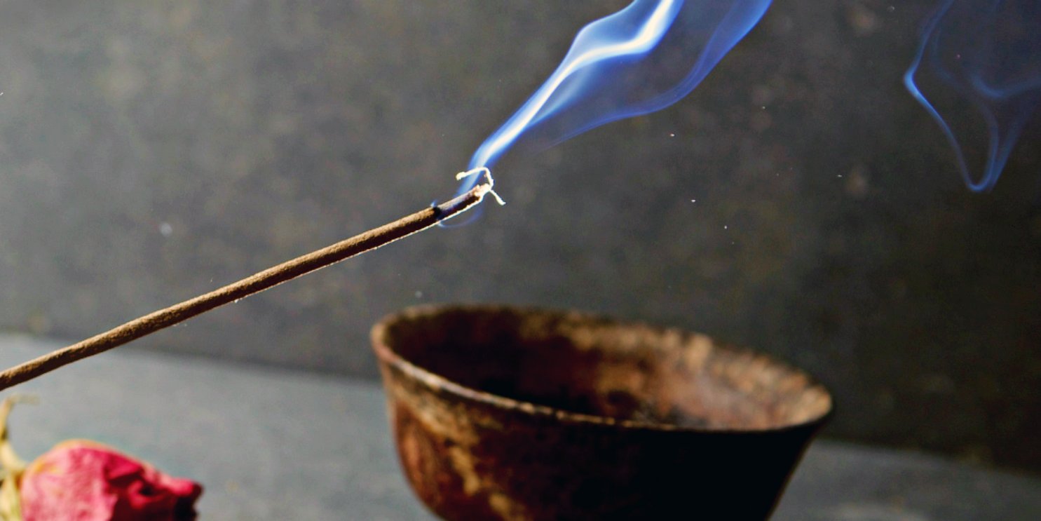 Burning Incense Stick next to a copper bowl and petals - Soulshine's Incense Section